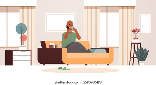 sick man blowing nose with handkerchief unhealthy african american guy cleaning snotty nose having flu sneeze sitting on sofa illness concept modern living room interior full length horizontal vector