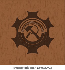 sickle and hammer icon inside badge with wooden background