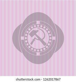 sickle and hammer icon inside badge with pink background