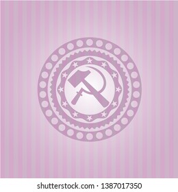 sickle and hammer icon inside badge with pink background