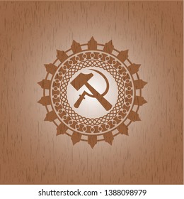 sickle and hammer icon inside badge with wood background