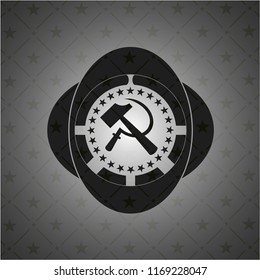 sickle and hammer icon inside black badge