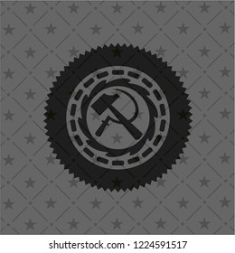 sickle and hammer icon inside black emblem