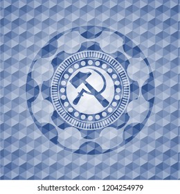 sickle and hammer icon inside blue badge with geometric pattern.