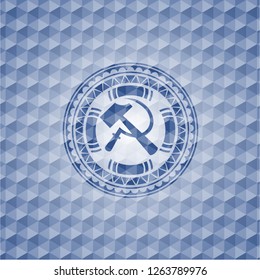 sickle and hammer icon inside blue polygonal emblem.