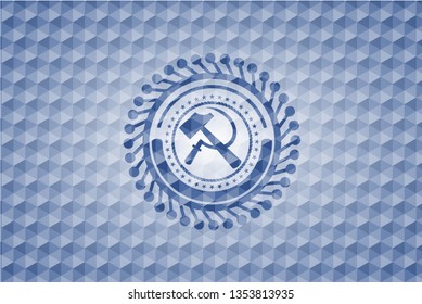 sickle and hammer icon inside blue polygonal badge.