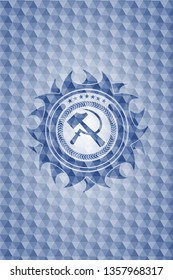sickle and hammer icon inside blue polygonal emblem.