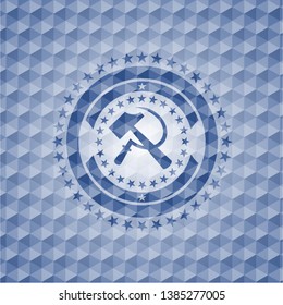 sickle and hammer icon inside blue emblem or badge with abstract geometric pattern background.