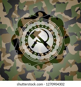 sickle and hammer icon inside camouflaged emblem