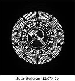 sickle and hammer icon inside chalkboard emblem written on a blackboard