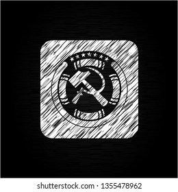 sickle and hammer icon inside chalkboard emblem written on a blackboard