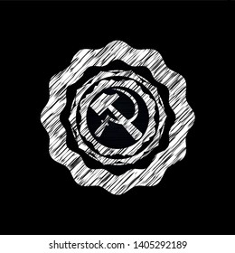 sickle and hammer icon inside chalkboard emblem on black board