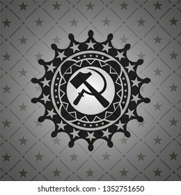 sickle and hammer icon inside dark badge or emblem