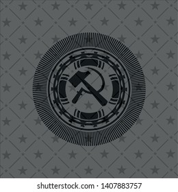 sickle and hammer icon inside dark badge
