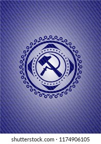 sickle and hammer icon inside emblem with jean background