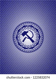 sickle and hammer icon inside emblem with denim texture