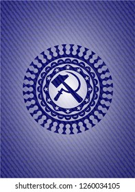 sickle and hammer icon inside emblem with denim high quality background