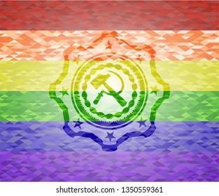 sickle and hammer icon inside emblem on mosaic background with the colors of the LGBT flag