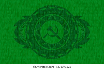 Sickle and hammer icon inside grass pasture realistic badge. Eco fancy background. Illustration. 