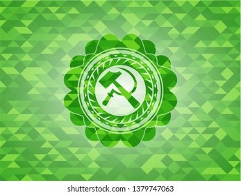 sickle and hammer icon inside green emblem with mosaic ecological style background