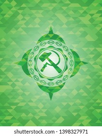 sickle and hammer icon inside green mosaic emblem