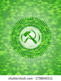 sickle and hammer icon inside green emblem. Mosaic background. 