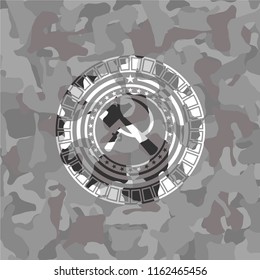 sickle and hammer icon inside grey camouflage texture