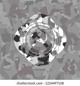 sickle and hammer icon inside grey camouflage texture