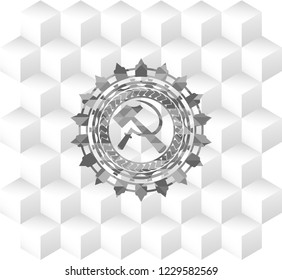 sickle and hammer icon inside grey emblem with geometric cube white background