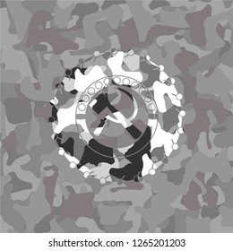 sickle and hammer icon inside grey camouflage emblem
