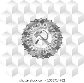 sickle and hammer icon inside grey badge with geometric cube white background
