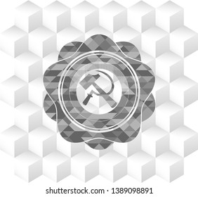 sickle and hammer icon inside grey badge with geometric cube white background