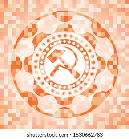sickle and hammer icon inside orange mosaic emblem