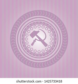 sickle and hammer icon inside pink emblem
