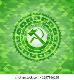sickle and hammer icon inside realistic green emblem. Mosaic background