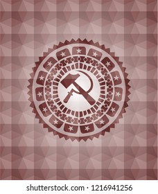 sickle and hammer icon inside red seamless geometric emblem.