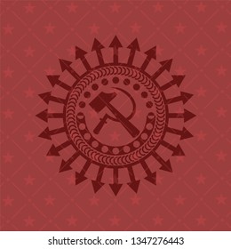 sickle and hammer icon inside red emblem