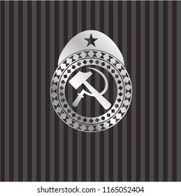 sickle and hammer icon inside silver badge or emblem
