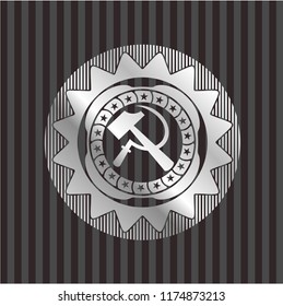 sickle and hammer icon inside silver emblem