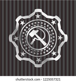 sickle and hammer icon inside silver badge or emblem