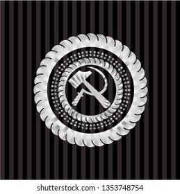 sickle and hammer icon inside silver badge or emblem