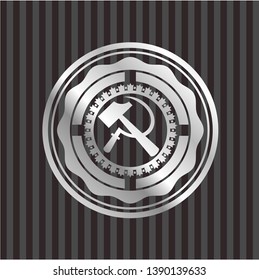 sickle and hammer icon inside silver badge