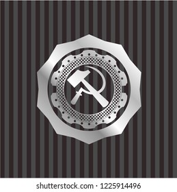 sickle and hammer icon inside silvery badge or emblem