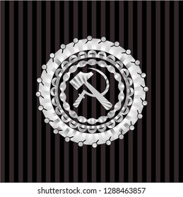 sickle and hammer icon inside silvery emblem or badge