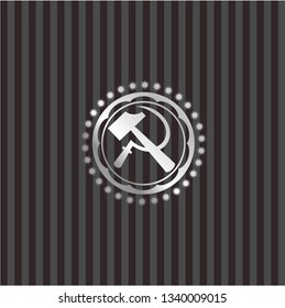 sickle and hammer icon inside silvery emblem or badge