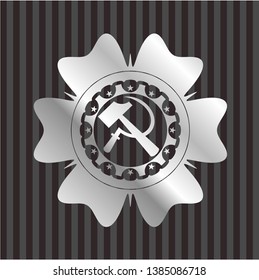 sickle and hammer icon inside silvery badge or emblem