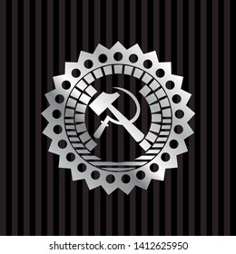 sickle and hammer icon inside silvery badge or emblem