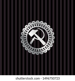 sickle and hammer icon inside silvery badge
