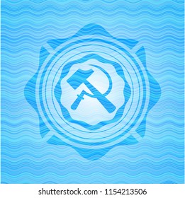 sickle and hammer icon inside sky blue water wave emblem background.