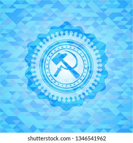 sickle and hammer icon inside sky blue emblem with mosaic background